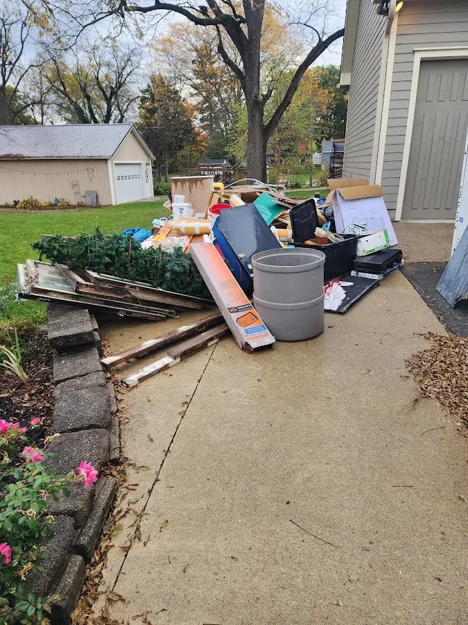Dumpster being loaded with debris for Roofing Dumpster Rental in Brady